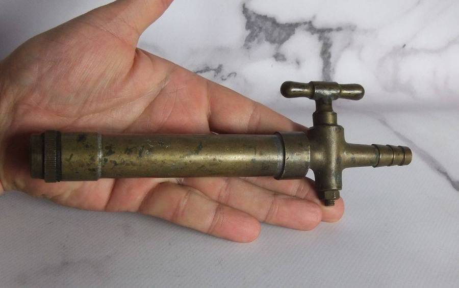 An old solid bronze or brass tap most likely alcohol related