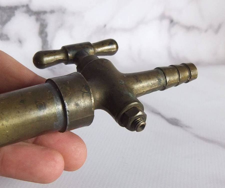 An old solid bronze or brass tap most likely alcohol related