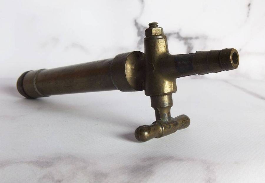 An old solid bronze or brass tap most likely alcohol related
