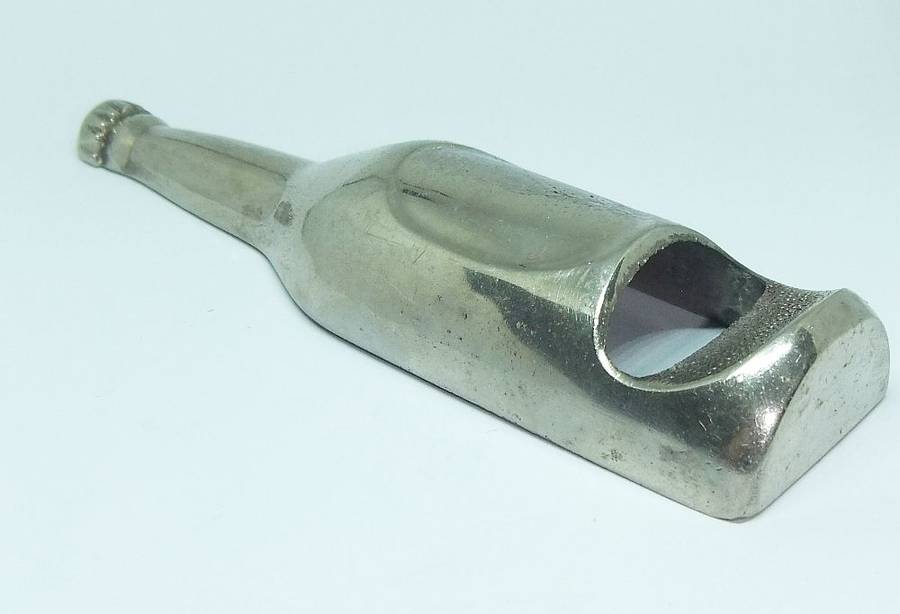 A VINTAGE BOTTLE FORM BOTTLE OPENER