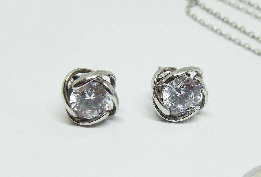 A beautiful sterling silver jewelry set including ring , earrings and necklace with pendant