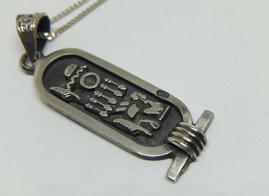 A detailed vintage Egyptian silver pendant with a sterling silver necklace