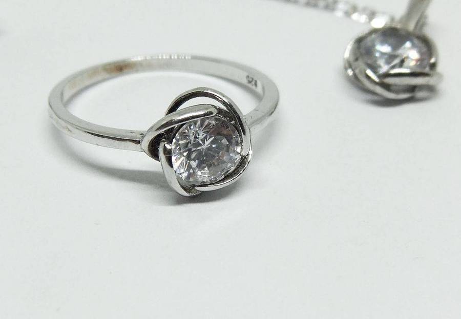 A beautiful sterling silver jewelry set including ring , earrings and necklace with pendant