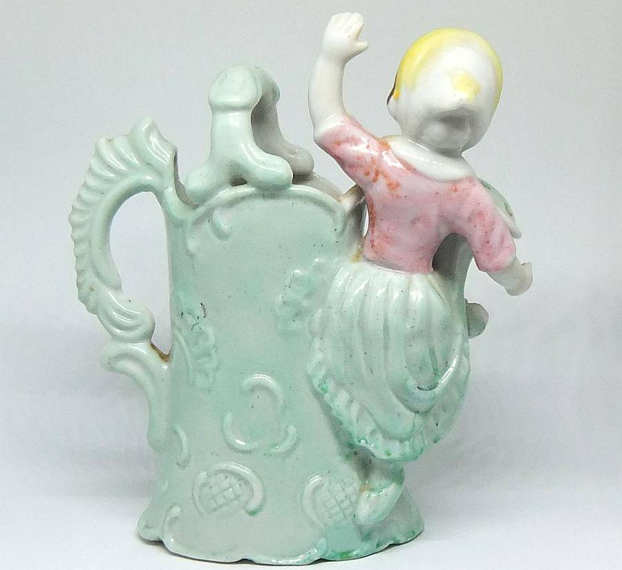 A RATHER KITSCH VINTAGE GIRL SITTING ON A WATERING CAN FIGURINE FLOWER POT IN GOOD CONDITION !!