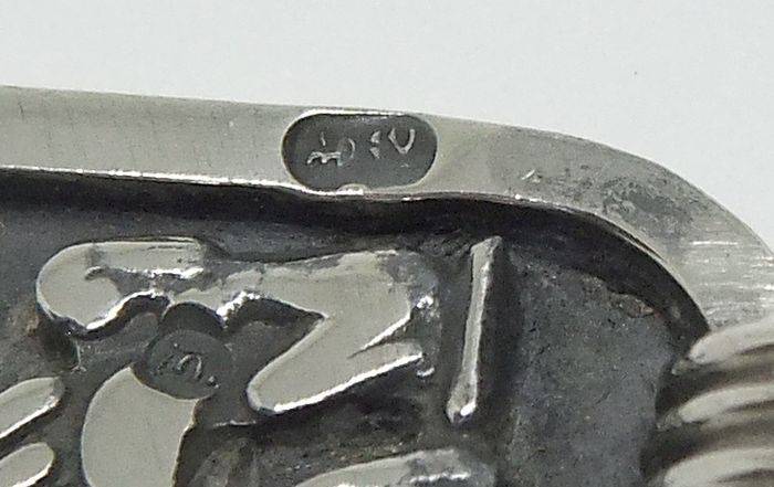 A detailed vintage Egyptian silver pendant with a sterling silver necklace
