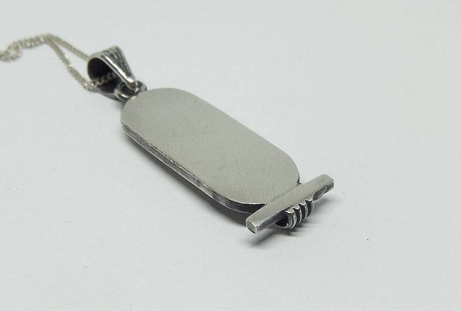 A detailed vintage Egyptian silver pendant with a sterling silver necklace