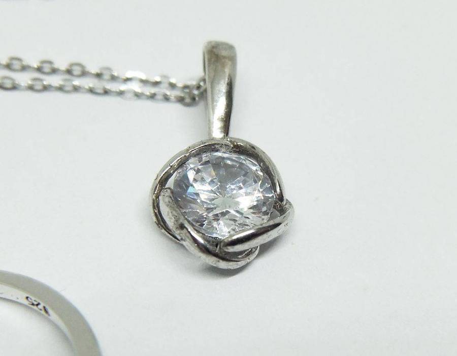 A beautiful sterling silver jewelry set including ring , earrings and necklace with pendant