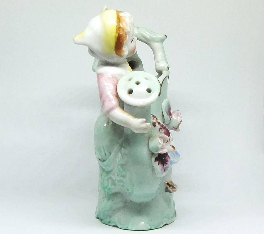 A RATHER KITSCH VINTAGE GIRL SITTING ON A WATERING CAN FIGURINE FLOWER POT IN GOOD CONDITION !!