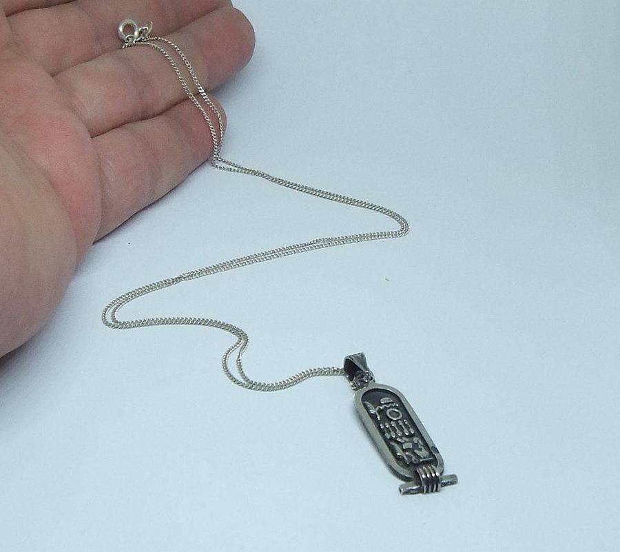 A detailed vintage Egyptian silver pendant with a sterling silver necklace