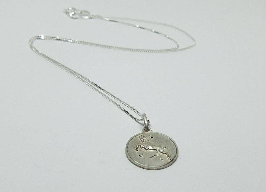 A vintage sterling silver Capricorn Zodiac sign pendant with a sterling silver necklace