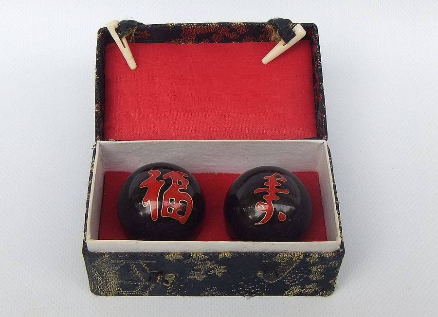 A pair of vintage Chinese iron chime balls with enamel decoration in original box