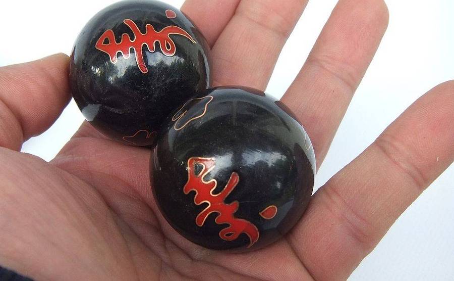 A pair of vintage Chinese iron chime balls with enamel decoration in original box