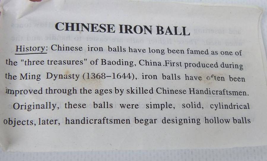 A pair of vintage Chinese iron chime balls with enamel decoration in original box
