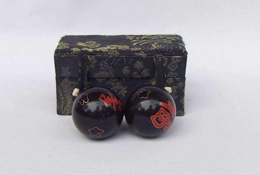 A pair of vintage Chinese iron chime balls with enamel decoration in original box