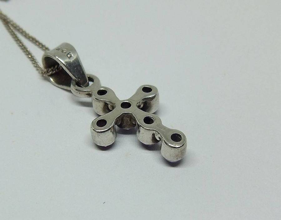 A lovely sterling silver cross pendant with cabochon Amethysts plus a sterling silver necklace