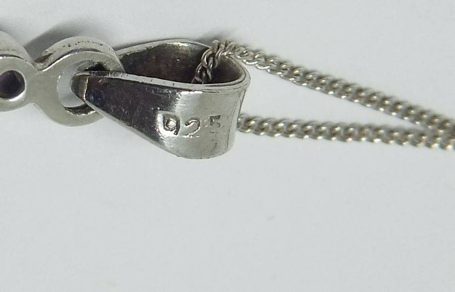 A lovely sterling silver cross pendant with cabochon Amethysts plus a sterling silver necklace