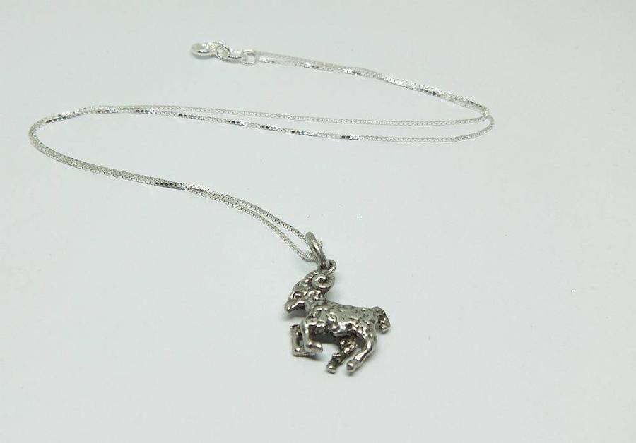 A vintage solid silver Aries Zodiac sign pendant with a sterling silver necklace