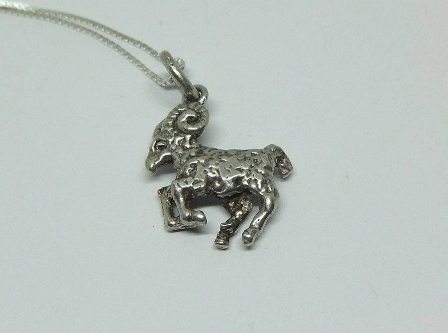 A vintage solid silver Aries Zodiac sign pendant with a sterling silver necklace