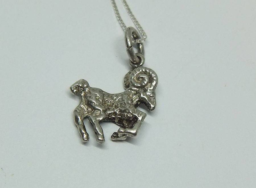 A vintage solid silver Aries Zodiac sign pendant with a sterling silver necklace