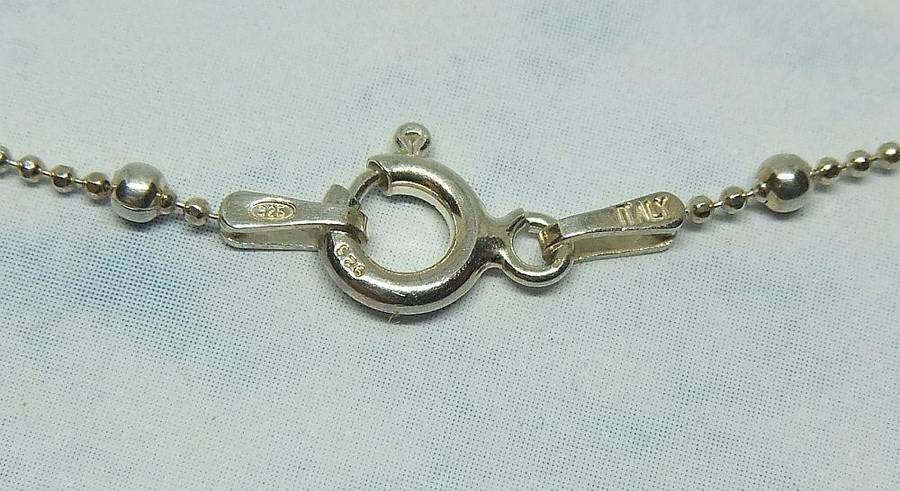 A SOLID STERLING SILVER "BALL" NECKLACE WITH A STERLING SILVER CROWN SHAPED PENDANT
