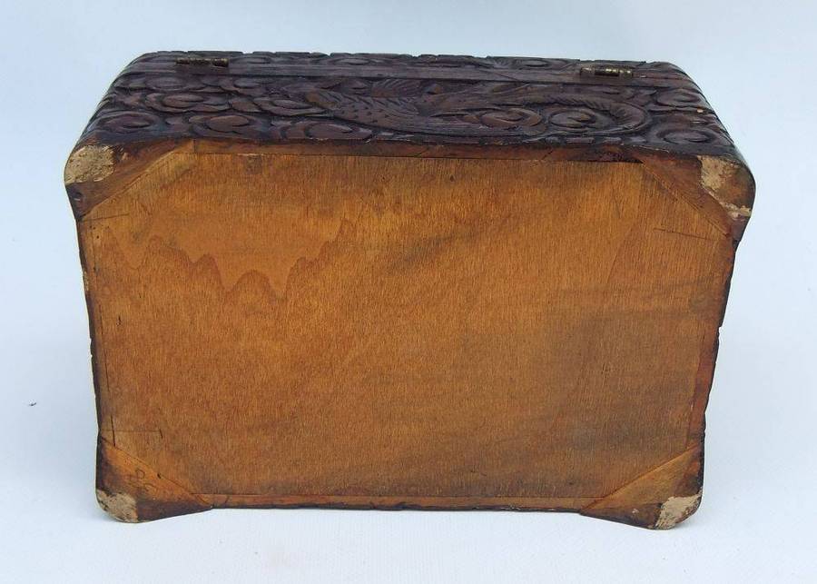 An old Chinese carved wood jewelry box with detailed Dragon and birds decoration