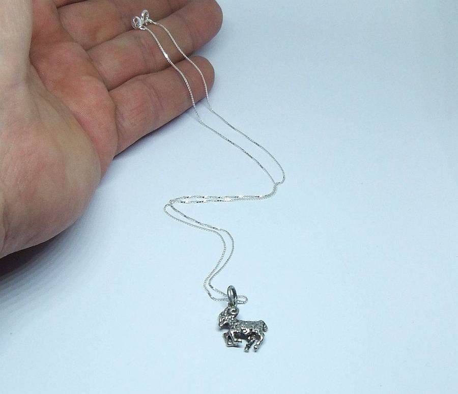 A vintage solid silver Aries Zodiac sign pendant with a sterling silver necklace