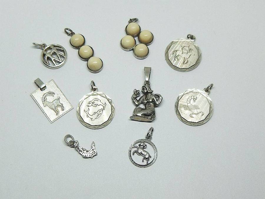 A lot of 9 vintage solid silver pendants and one sterling silver island charm
