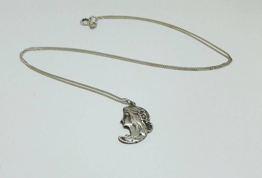 A beautiful solid sterling silver Art Nouveau style pendant with a sterling silver necklace