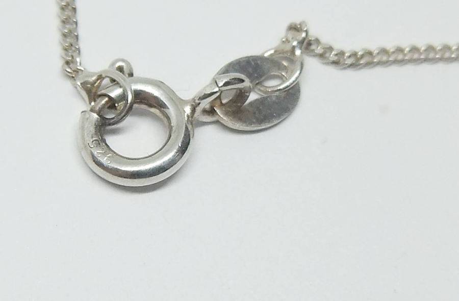 A beautiful solid sterling silver Art Nouveau style pendant with a sterling silver necklace