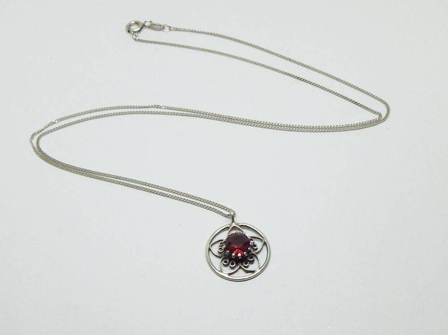 An eye catching vintage sterling silver pendant with faceted red inset plus sterling silver necklace