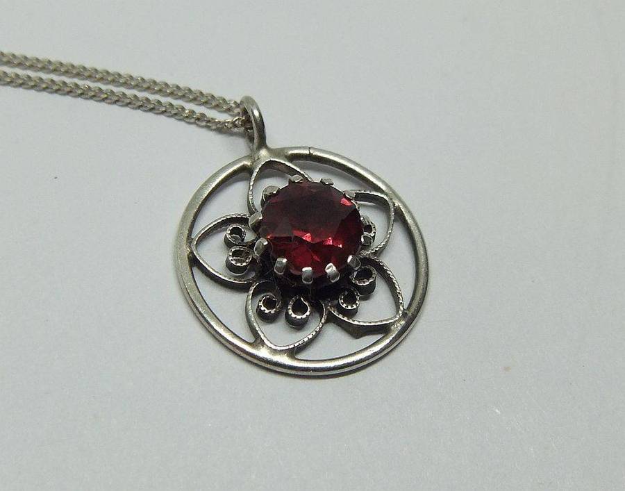 An eye catching vintage sterling silver pendant with faceted red inset plus sterling silver necklace