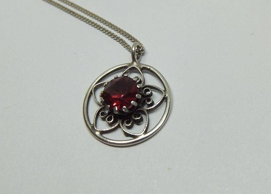 An eye catching vintage sterling silver pendant with faceted red inset plus sterling silver necklace
