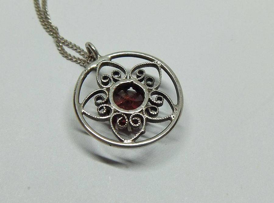 An eye catching vintage sterling silver pendant with faceted red inset plus sterling silver necklace