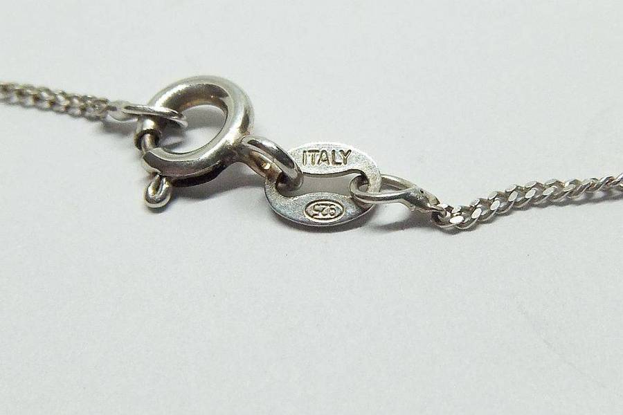 An eye catching vintage sterling silver pendant with faceted red inset plus sterling silver necklace