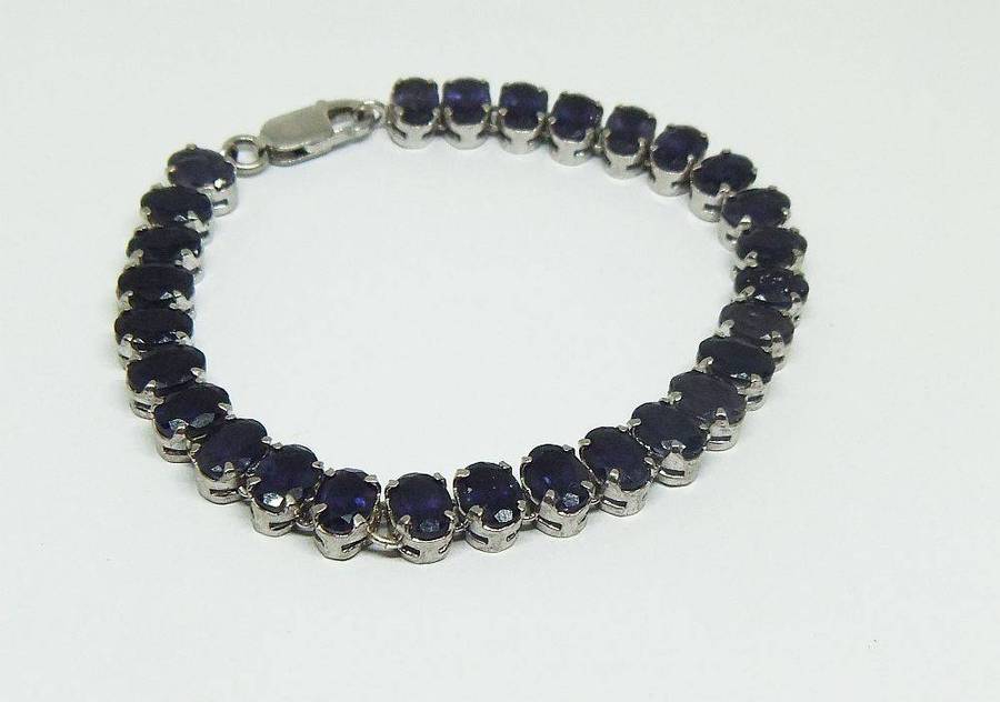 A gorgeous sterling silver bracelet with 28 faceted dark blue insets