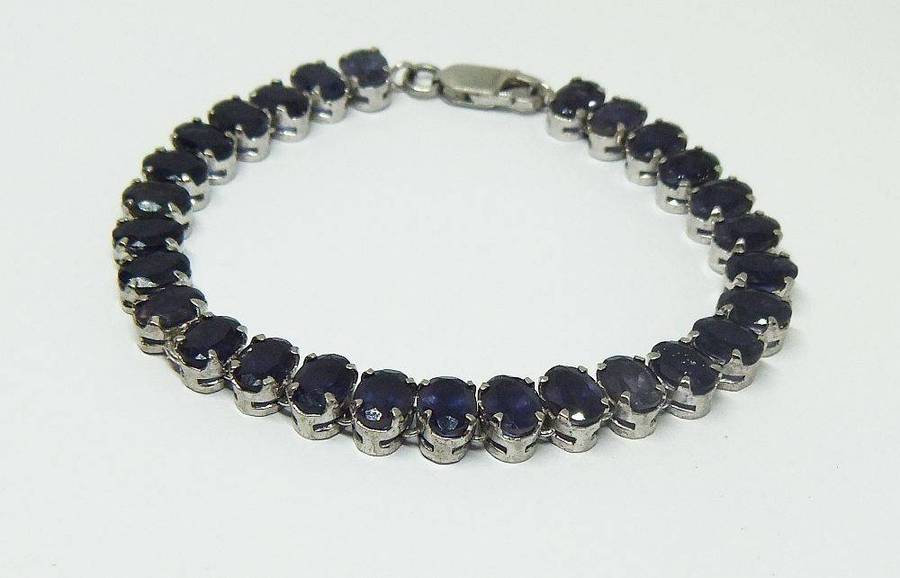 A gorgeous sterling silver bracelet with 28 faceted dark blue insets