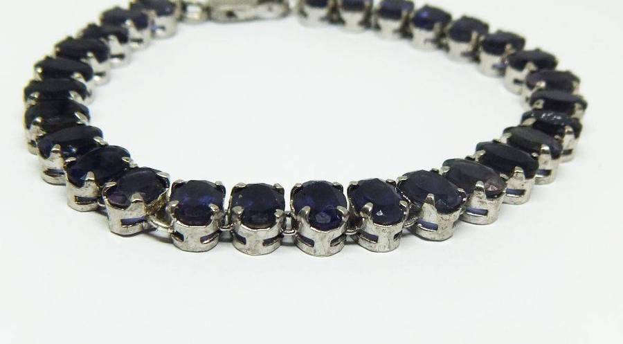 A gorgeous sterling silver bracelet with 28 faceted dark blue insets