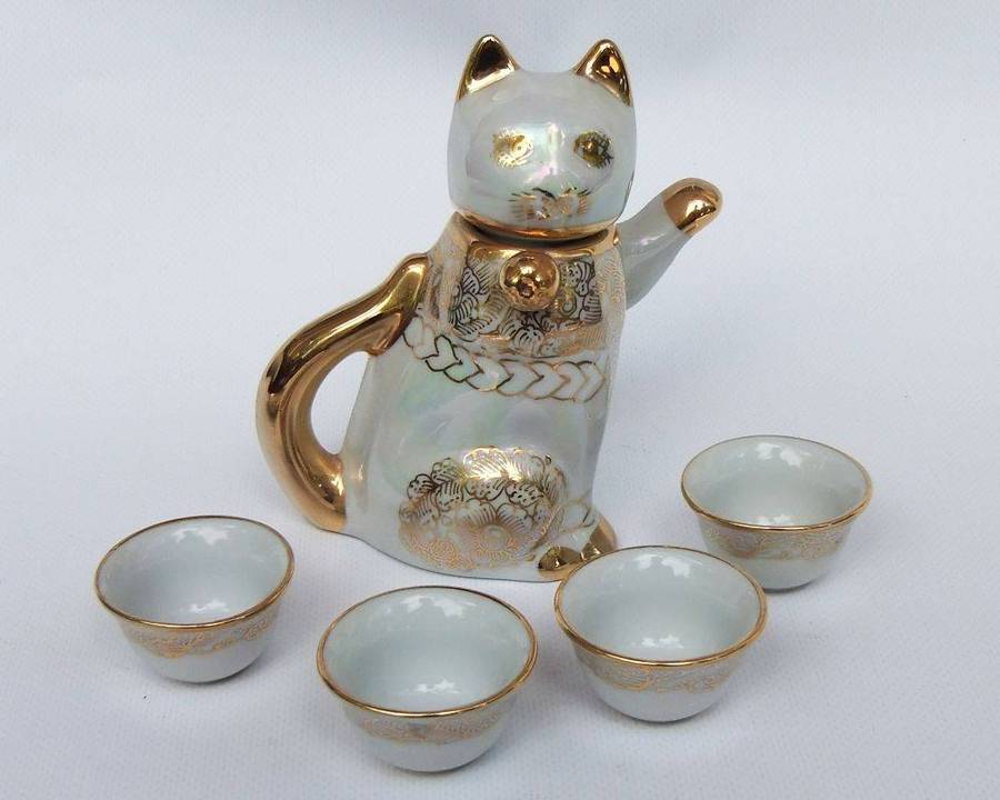 An adorable vintage hand painted porcelain kitty cat themed drink set with rainbow lustre