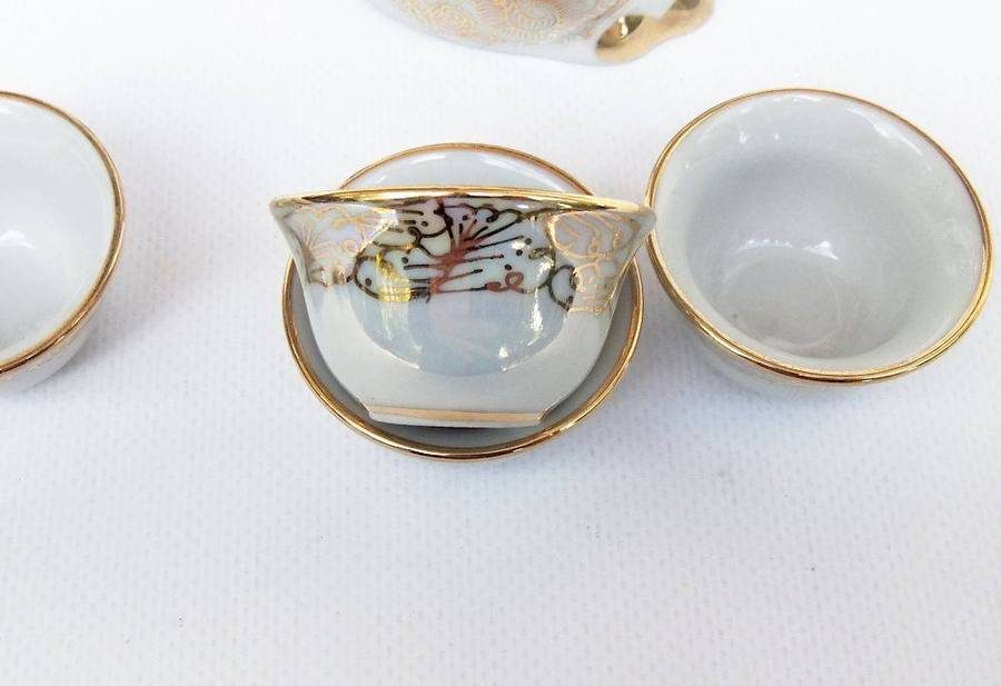 An adorable vintage hand painted porcelain kitty cat themed drink set with rainbow lustre