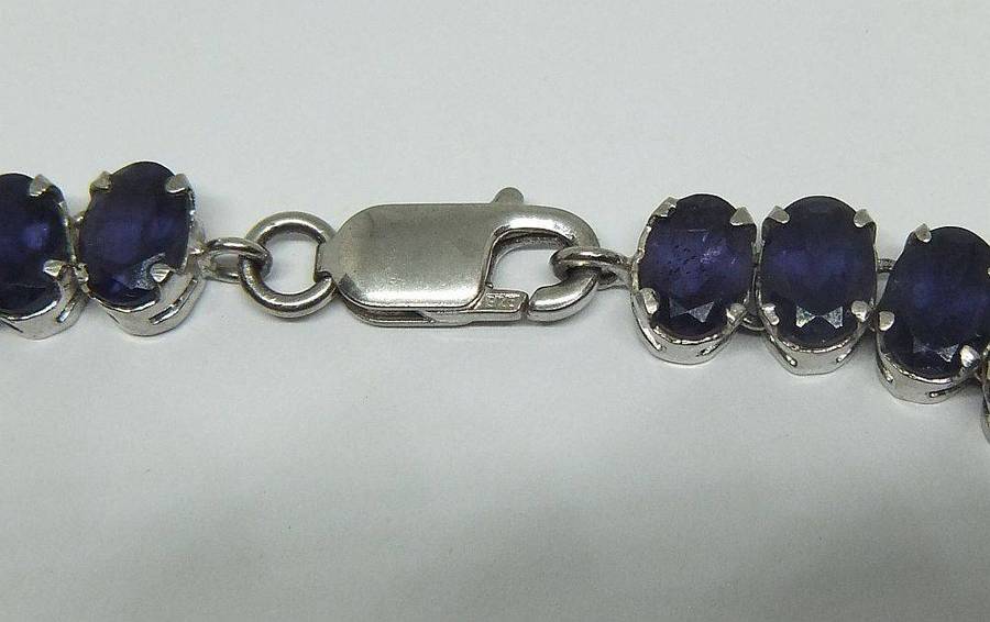 A gorgeous sterling silver bracelet with 28 faceted dark blue insets