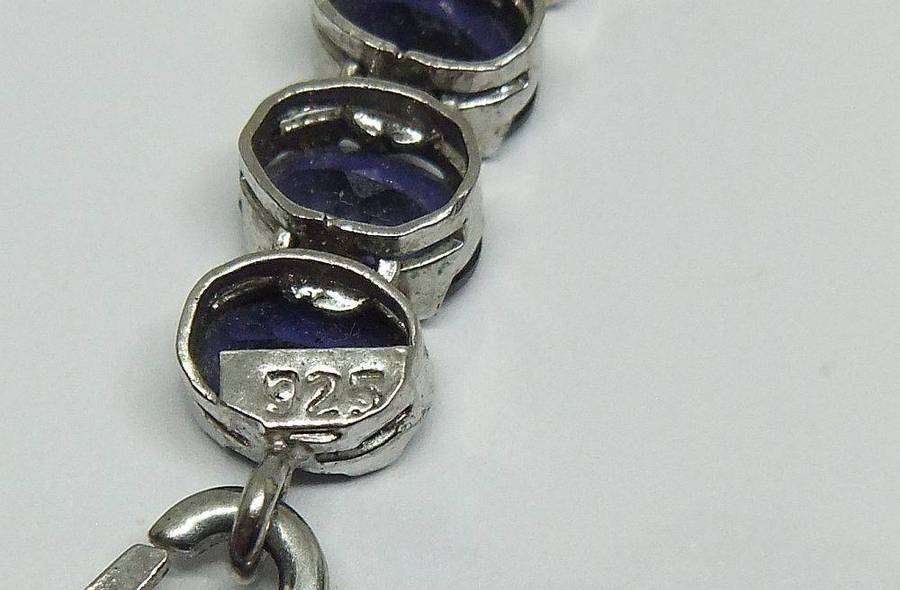 A gorgeous sterling silver bracelet with 28 faceted dark blue insets