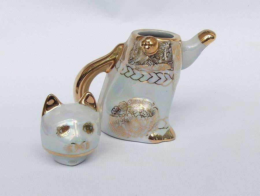 An adorable vintage hand painted porcelain kitty cat themed drink set with rainbow lustre