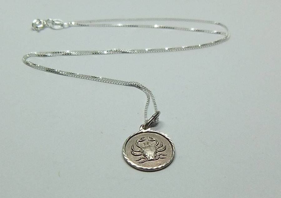 A vintage sterling silver Cancer Zodiac sign pendant plus a sterling silver necklace
