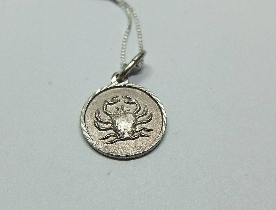 A vintage sterling silver Cancer Zodiac sign pendant plus a sterling silver necklace