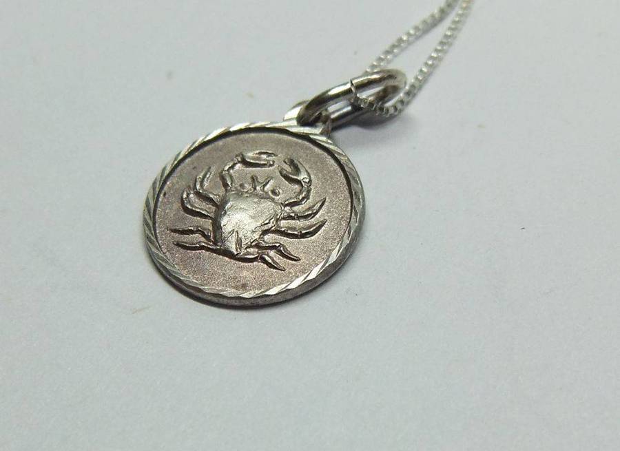 A vintage sterling silver Cancer Zodiac sign pendant plus a sterling silver necklace