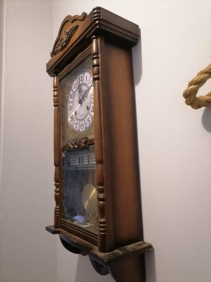 A vintage Blessing 31 day clock w/ day & date in a wood wall casing. Lifespace Sale - With Key