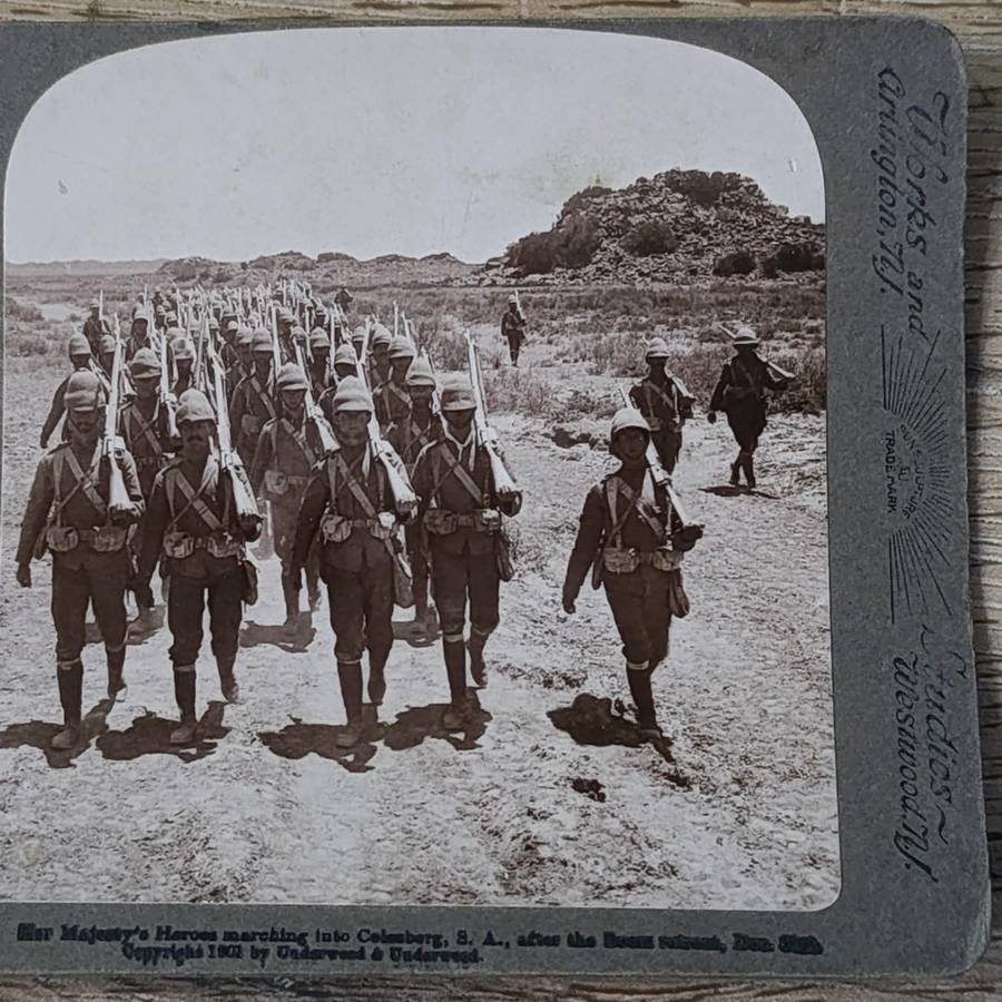 Boer War stereoscope card - Her Majesty's Heroes marching into Colesberg, S.A