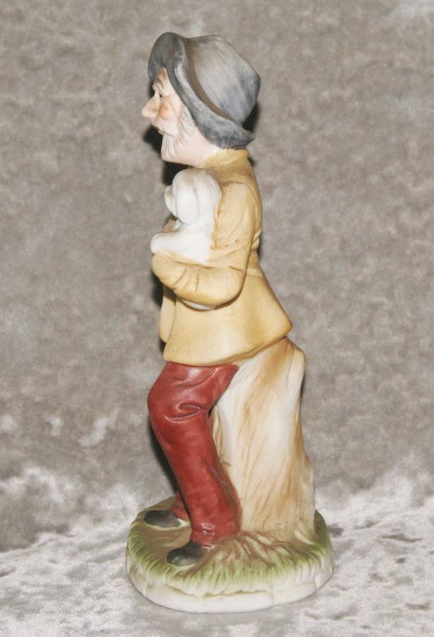 Vintage ceramic figurine of man holding dog