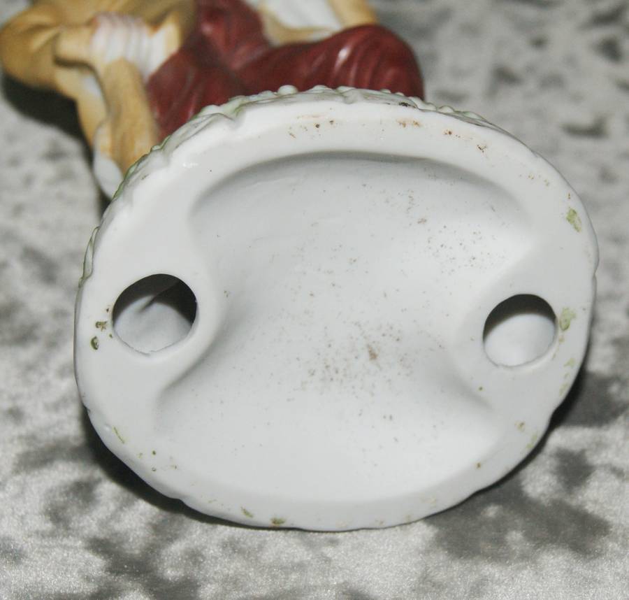 Vintage ceramic figurine of man holding dog