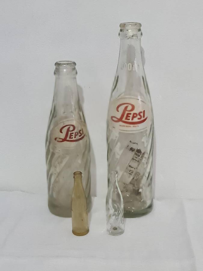 X4 Differant size and age Pepsi Cola bottles.